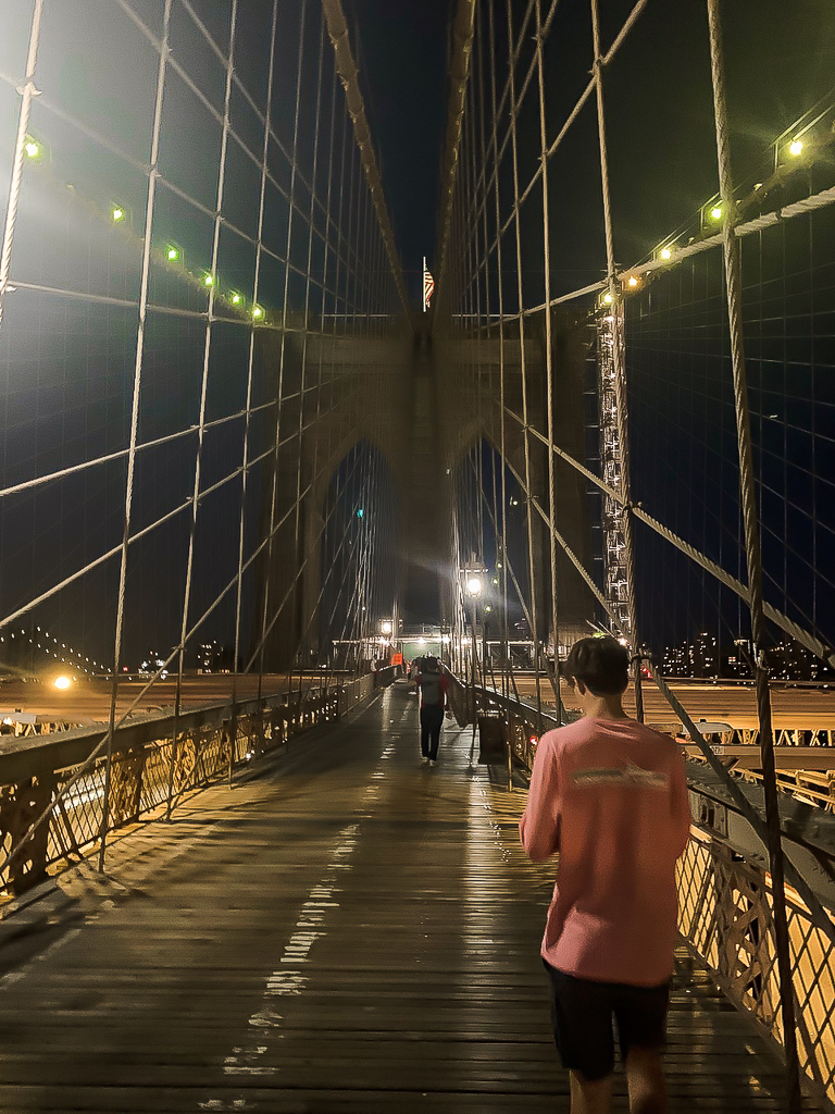 Booklyn bridge night time walk with teenage son new york lights